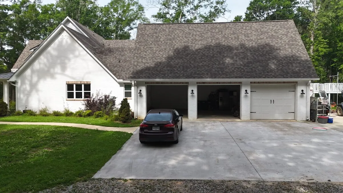 White brick home with a new architectural shingle roof