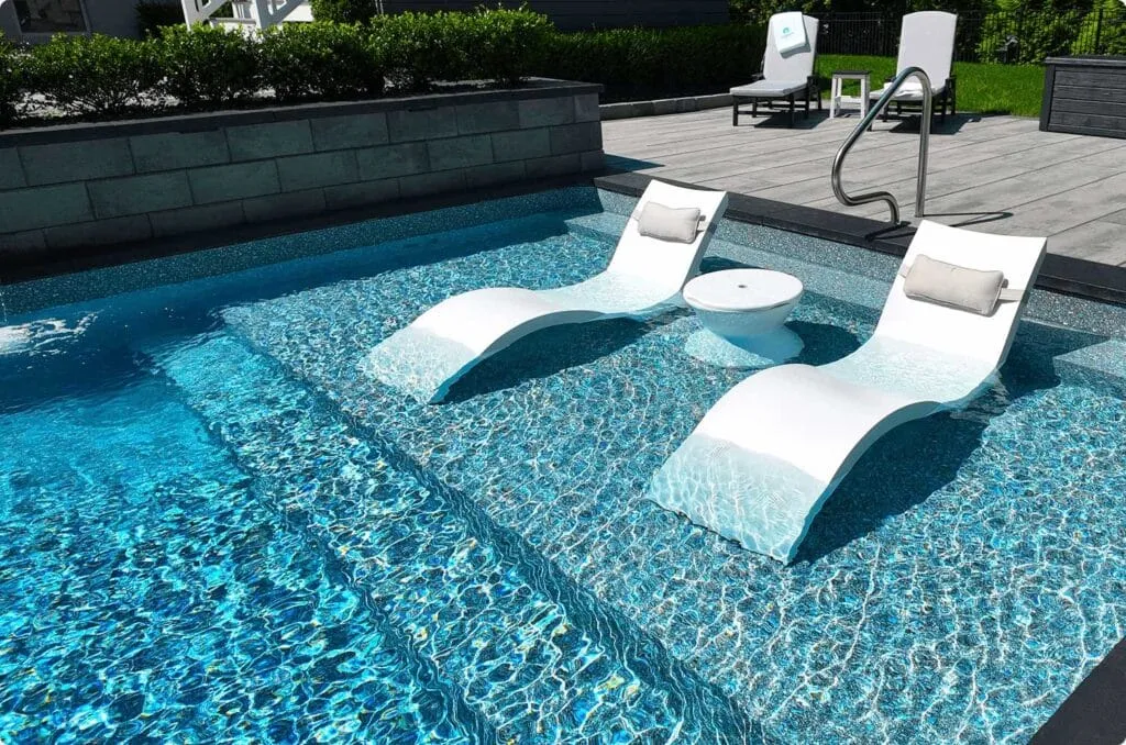 Fiberglass pool tanning ledge sun shelf in use